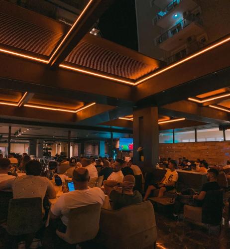 a group of people sitting in chairs in a room at Hotel Frojd - Beach Front Resort in Shëngjin