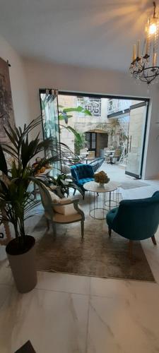 a living room with a potted plant and a couch at Casal Annunzia Boutique Accomodation in Tarxien