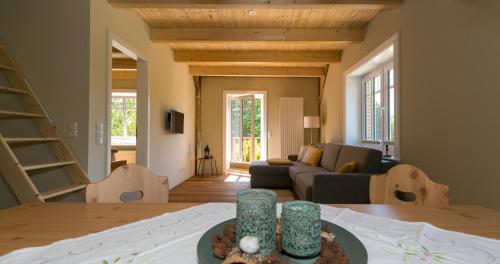 a living room with a couch and a table at Ferienhof-Eiderdeich Wohnung Hertha in Delve
