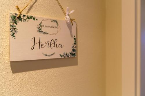 a sign that says hello hanging on a wall at Ferienhof-Eiderdeich Wohnung Hertha in Delve