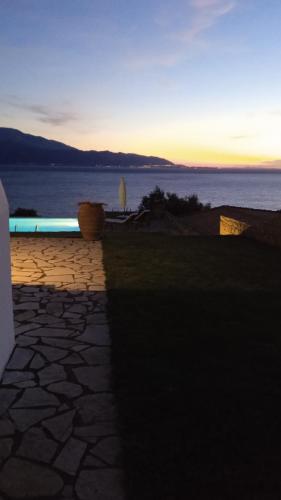 a sunset over a body of water with a pool at PRINCESS OF BLUE EAGLES RETREAT in Skaloma