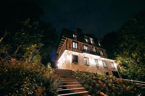 a building with stairs leading up to it at night at La Garçonnière Genval in Rixensart