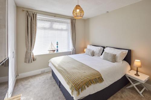 a bedroom with a large bed and a window at Host & Stay - Seagull Cottage in Bridlington
