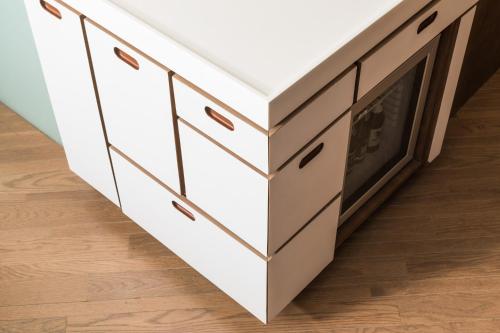 a white kitchen island with drawers and cabinets at Volve Hotel Bangkok in Bangkok