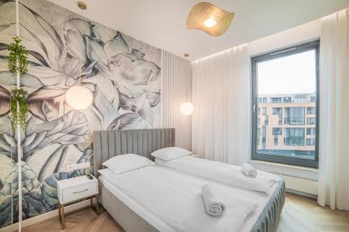 a bedroom with two beds and a mural on the wall at Apartament Amber Centrum Lux in Gdańsk
