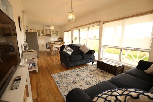 a living room with a couch and a table at Bridgecroft Villa - French Provincial in Richmond with spa in Richmond