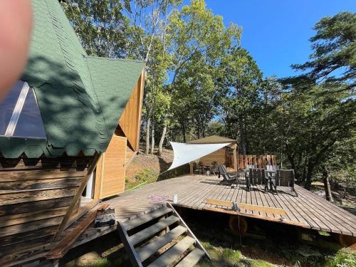 a wooden deck with a table and chairs on it at North Villge Hirugano - Vacation STAY 21286v in Gujo