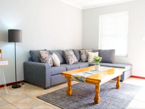 a living room with a couch and a coffee table at De Hoek Selfsorg Eenhede in Beaufort West