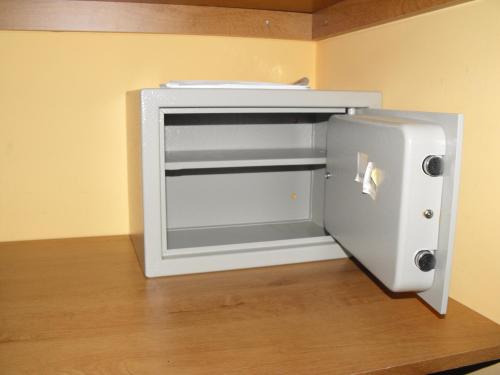 a refrigerator with its door open sitting on a wooden floor at Hotel Restaurante Pontiñas in Lalín