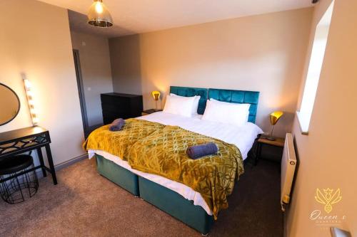 a bedroom with a large bed with a yellow blanket at Cheerful Queens Quarters Boutique Rooms in Hartford