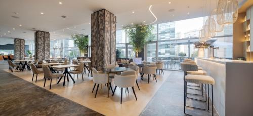 a restaurant with tables and chairs in a building at Ilunion Atrium in Madrid