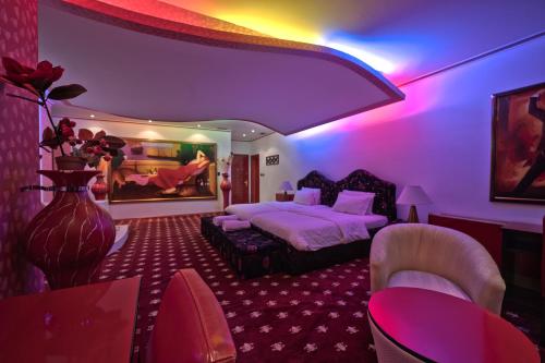 a hotel room with a bed and purple lighting at Hotel Rosa Blu in Tirana