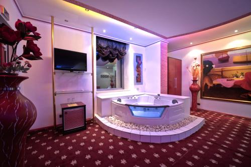 uma grande casa de banho com uma grande banheira num quarto em Hotel Rosa Blu em Tirana