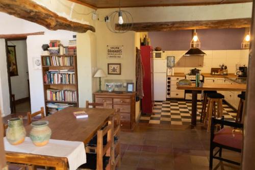 eine Küche und ein Wohnzimmer mit einem Tisch und einer Theke in der Unterkunft La Esmeralda in Amaichá del Valle