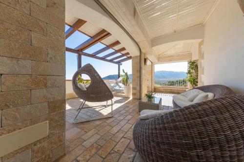 a living room with a stone wall at Hotel Residence Il Porto in Mattinata