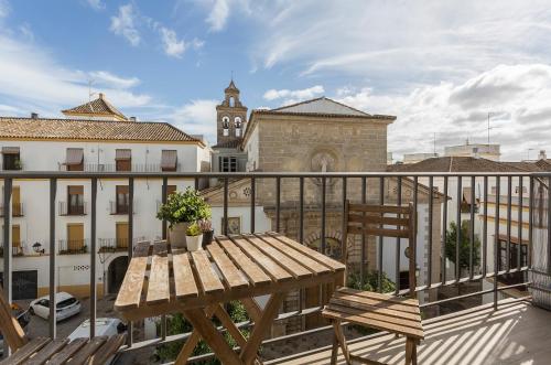 a wooden table and chair on a balcony at Luxe Vista Histórico 5 rooms 4 baños in Jerez de la Frontera