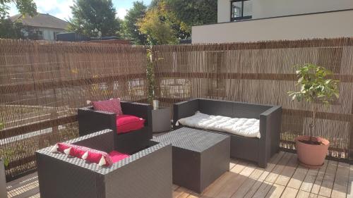 a patio with two chairs and a couch on a fence at Happy casita Disneyland Paris in Chalifert