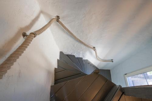 a rope hanging from a ceiling with an umbrella at SHWAY - The Saffron Dress in Antwerp