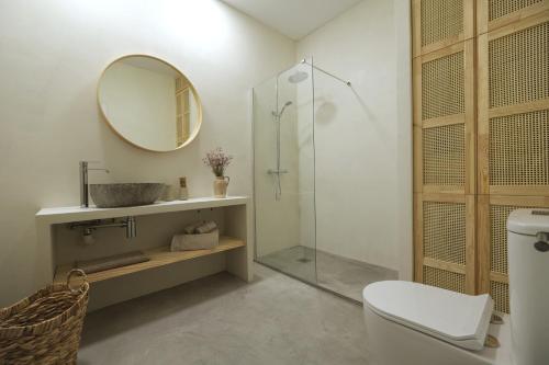 a bathroom with a shower and a sink and a mirror at Donna Suite in Arrecife