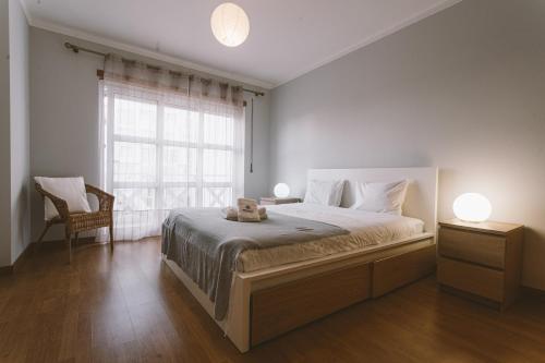 a bedroom with a large bed and a window at Best Houses 66 - Côté Dune in Ferrel