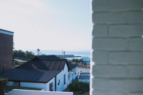 a view of the ocean from a building at HARBOUR VIEW FUNKY AND ECLECTIC TWO BEDROOM HOME in Mossel Bay