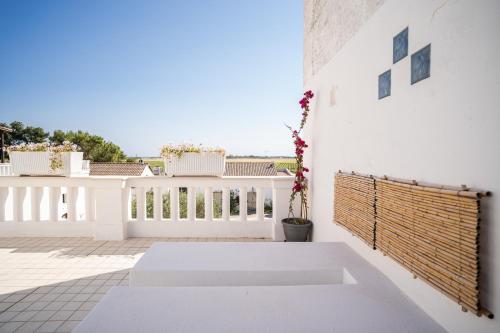 a balcony with white walls and a white fence at Tenuta del Barco WineRestaurant and Hospitality in Pulsano