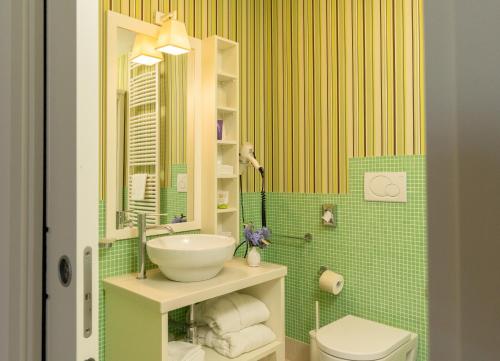 a bathroom with a sink and a toilet at Hotel Residence Il Porto in Mattinata