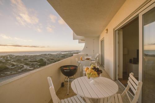 a balcony with a table and chairs and a view of the ocean at Best Houses 64 - Sunset Beach in Ferrel