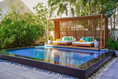 an infinity pool with a gazebo in a backyard at Private Pool Apt. Five Palm Jumeirah up to 6guest in Dubai