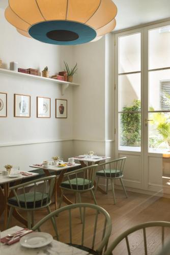 a dining room with tables and chairs and a chandelier at Casa G. Firenze in Florence