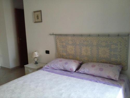 uma cama com duas almofadas num quarto em Da Antonio em Càbras