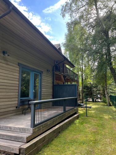 a front porch of a house with a deck at Rugio namai-Rye house in Palanga