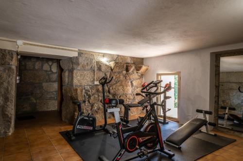 a gym with two exercise bikes in a room at Matos Casas de Campo in Cabeceiras de Basto