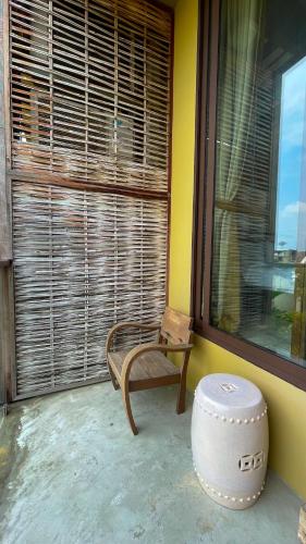 a room with a chair and a large window at Villa Bangkok in Bangkok