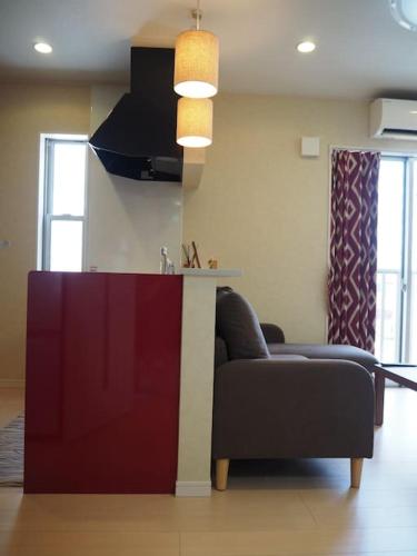 a living room with a couch and a table at Harbour Inn & Suites 202 in Niigata