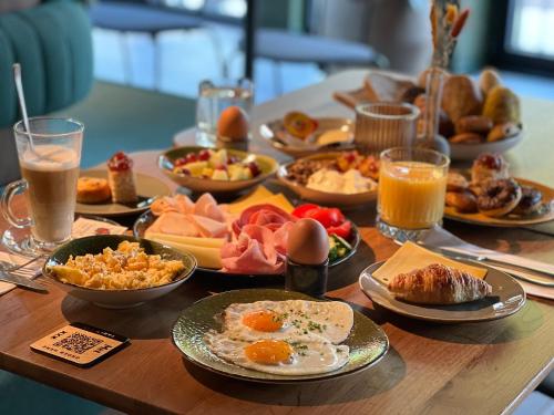 a table full of breakfast foods and drinks at Met Hotel Amsterdam in Amsterdam