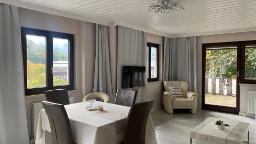 a dining room with a white table and chairs at Bad Ischl - Central & Quiet Apartment in Bad Ischl