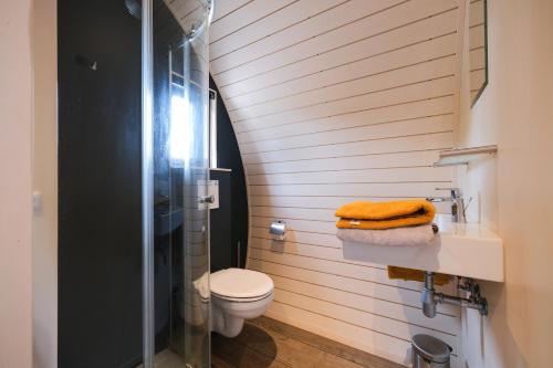 a bathroom with a toilet and a glass shower at GreenFloat Boskoop - #1 in Boskoop