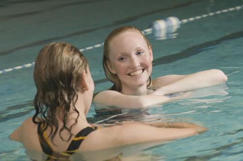 dos mujeres en el agua en una piscina en The Hotel Captain Cook, en Anchorage