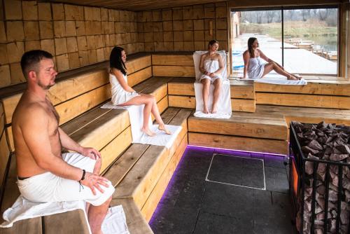 a group of people sitting in a sauna at Hotel Azzun Orient SPA&Wellness in Kromerowo