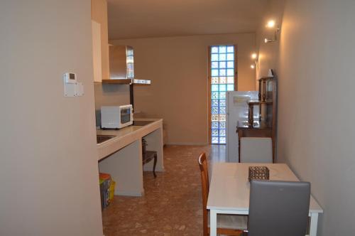 a kitchen and dining room with a table and a table and chairs at Podere San Marco in Bonate di Sopra