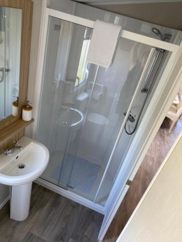 a bathroom with a shower and a sink at Number 57 Brynteg in Caernarfon