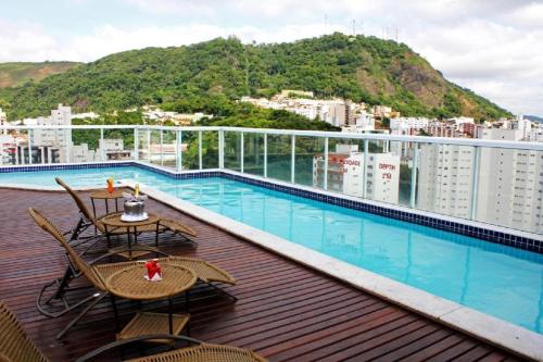 a balcony with a pool on top of a building at Victory Suites in Juiz de Fora