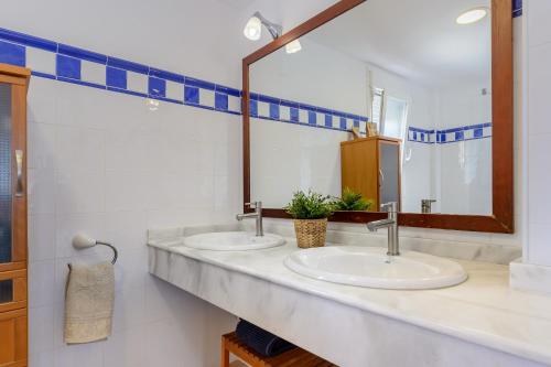 two sinks in a bathroom with two mirrors at Edificio can Sord Apto nº 2 in La Savina