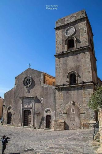 an old stone building with a clock tower at Savoca Loft S. Antonio in Savoca 
