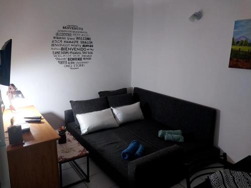 a living room with a black couch and a table at Departamento Ciudad Mendoza in La Cieneguita