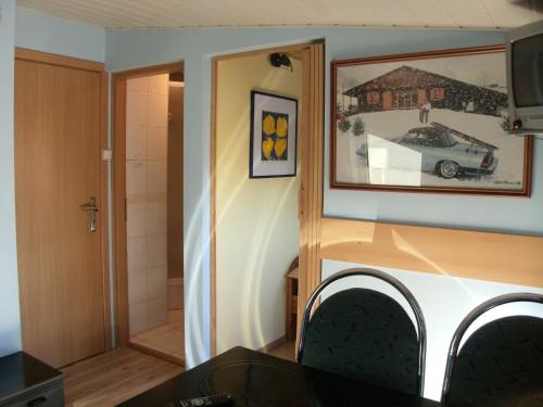 a room with a bathroom with a car picture on the wall at Willa pod piórem in Szczyrk