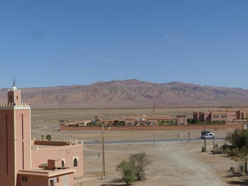 a view of a desert town with a church and a street at Dar Diafa Chez Anaam in Er Rachidia
