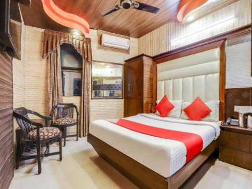 a bedroom with a bed and a desk and a chair at Hotel R DELUXE "Couple Friendly Vaccinated Staff" in New Delhi