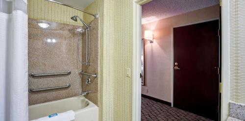 a bathroom with a shower and a bath tub at Holiday Inn Express Hotel & Suites Christiansburg by IHG in Christiansburg